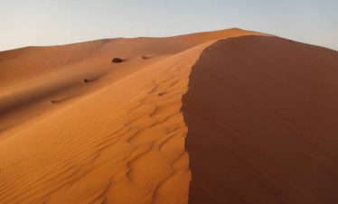 Sunset over the desert of Al Khatim in Abu Dhabi, Emirates